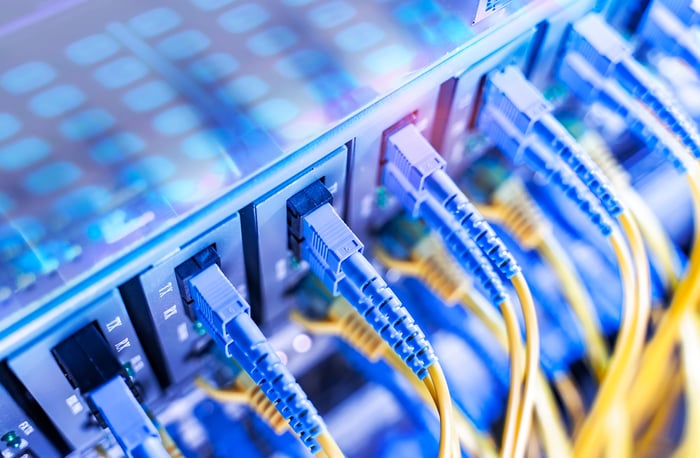 Close-up view of multiple blue and yellow computer networking cables.