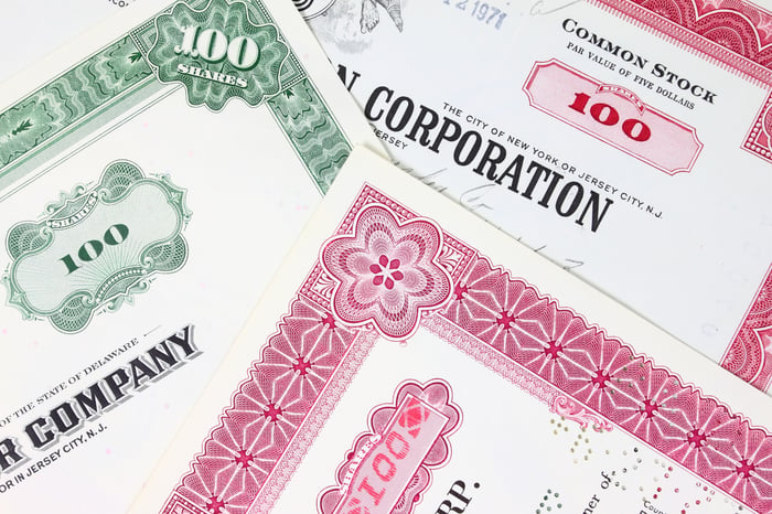 Different stock certificates spread out.