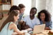 GettyImages-happy people gather around a computer