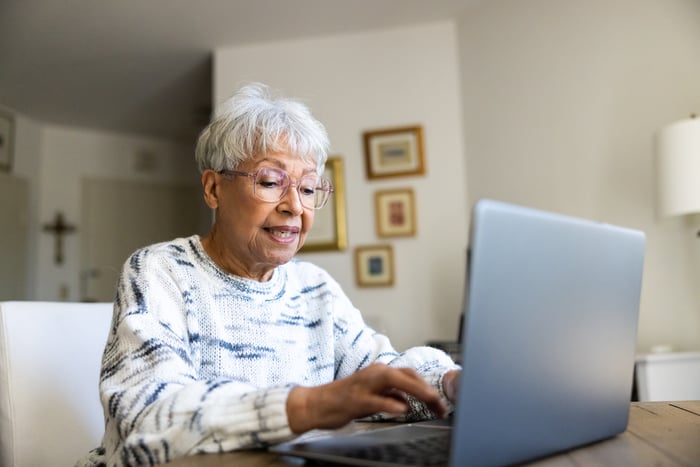 Person using laptop in their home.