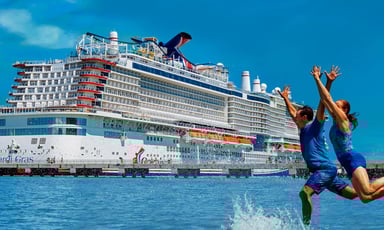 two people jumping in to water in front of carnival cruise line ship_Carnival_Cruise_Lines_CCL