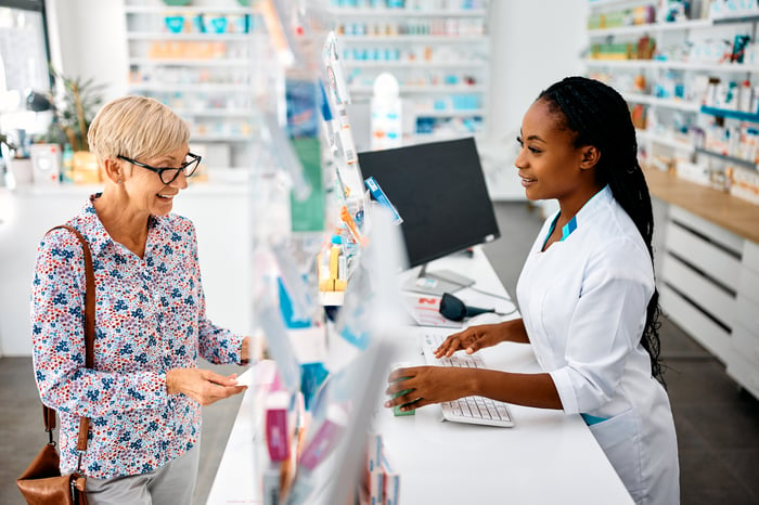 A person filling a prescription at a pharmacy.