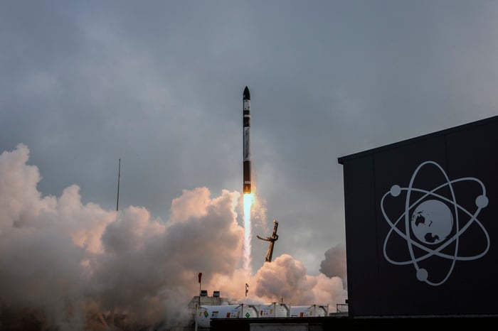 An image shows Rocket Lab's Electron rocket taking off from a launch pad. 