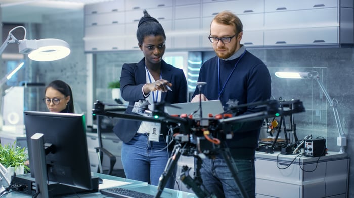 Engineers programming a drone