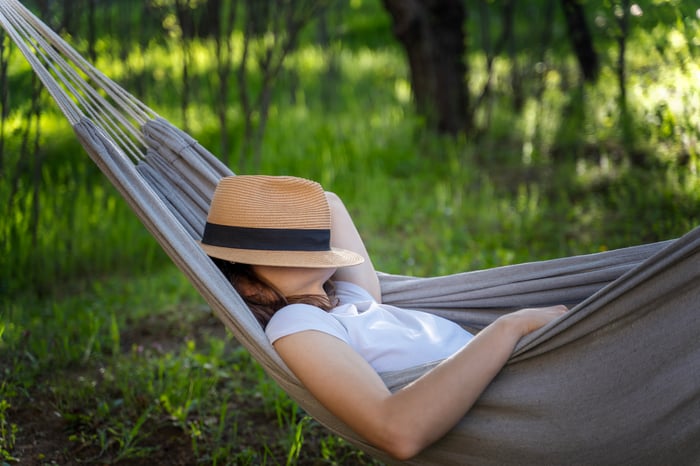 An investor relaxing in a hammock.