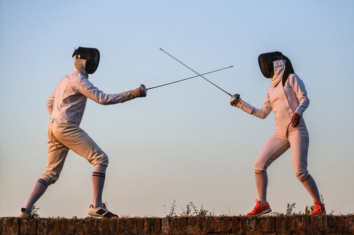 Two people fencing.