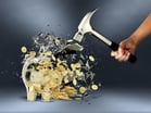 person smashing piggy bank with hammer