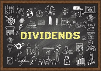 24_10_15 The word Dividends in yellow on a blackboard with doodles around it _MF Dload-1132x800-b2e72a2