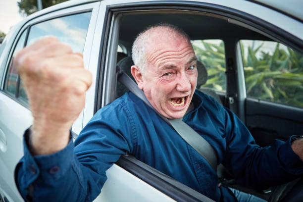 Someone angry behind the wheel of a car.