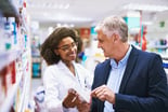 Pharmacist helping a customer.