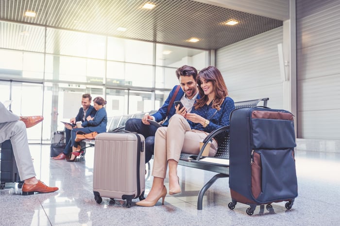 People sitting at an airport gate.