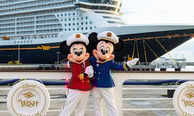 mickey and minnie mouse in front of disney cruise line called disney wish_Disney