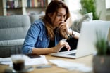 Worried investor looking at their laptop.