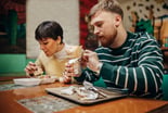 People eating wraps at a restaurant.