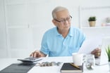 A person calculating their finances.