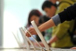 people shopping at computer store laptops