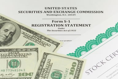 S-1 stock prospectus covered in a stock certificate and $100 bills