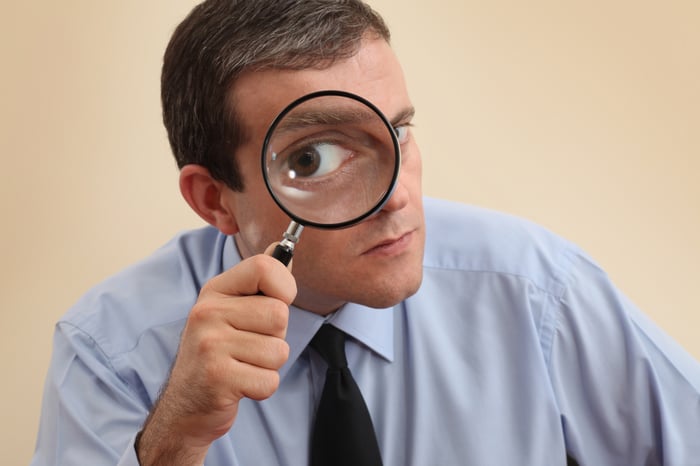 A person looking through a magnifying glass.