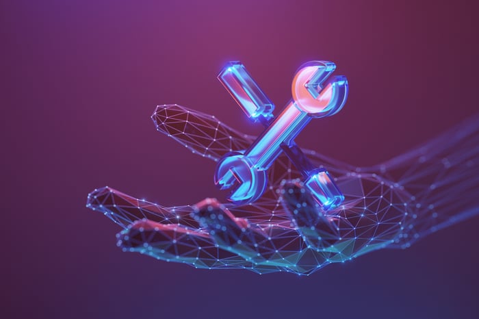 Rendering of a digital hand holding a wrench and a screwdriver. 