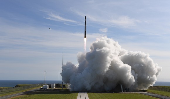 An image of Rocket Lab's Electron vehicle lifting off from a launch pad.