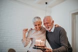 Senior couple birthday cake GettyImages-906043636