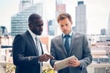 Business people looking at a tablet.