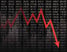 Red down arrow on a black backdrop of tickertape prices.