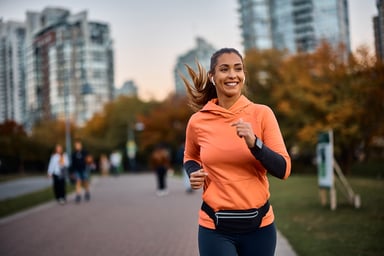 A person smiling while going for a run with headphones 2