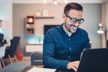 Man 30s smiling laptop GettyImages-1181035364