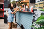 A person paying with a credit card at an outdoor stall