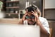 Person looking at laptop screen with head in hands