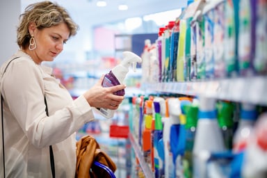 choosing domestic cleaning product by the supermarket shelf