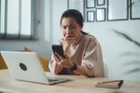 Person checking her phone upset
