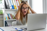 Woman with horrified face in front of laptop_GettyImages-1435231909-1200x800-9b9f185