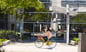 person biking on google campus with google logo reflection in background_alphabet_google
