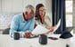 Couple looking at documents together in kitchen