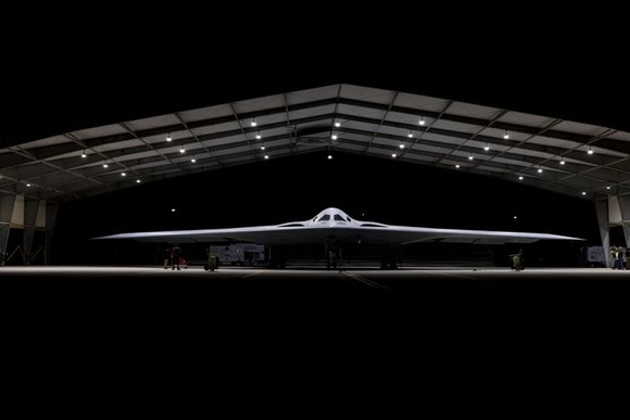 Northrop Grumman B-21 Raider stealth bomber in a hangar.