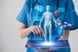 Doctor uses a pad to review a 3-D hologram x-ray.