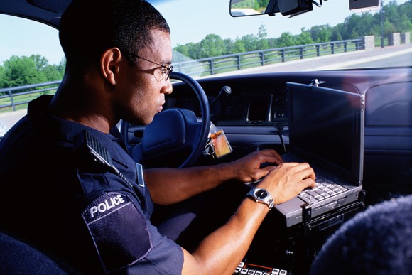 A police officer using his laptop.