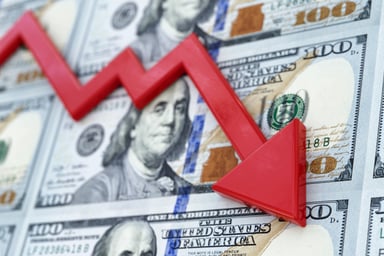 Downward red arrow with a background of US currency