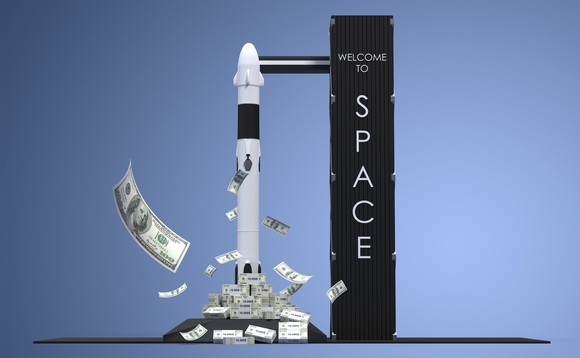 Rocket standing on a pile of money next to a launch tower that reads Welcome to space.