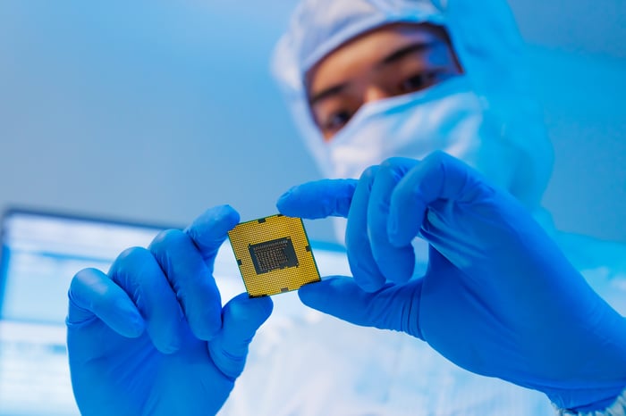 A person looking at a microchip.