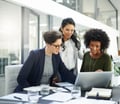 GettyImages-three investors look at a computer_in office