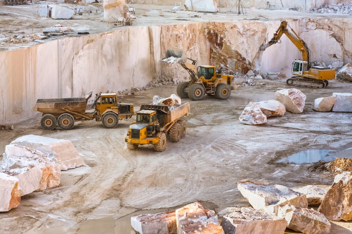 Construction vehicles working at a job site.