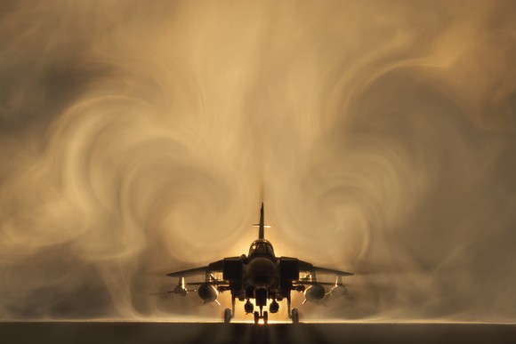 A fighter jet taking off.