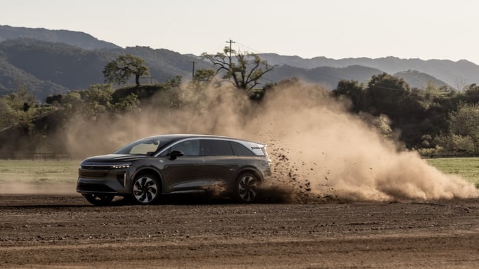 An SUV driving in the dirt.