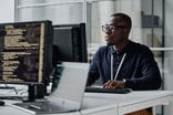 Man works on cybersecurity at a computer