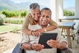 A happy couple looking at a computer together