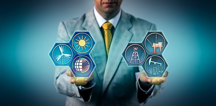 A person holding energy industry icons in their hands.