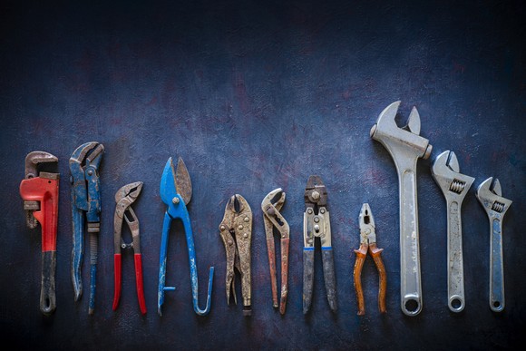 A line up of wrenches and pliers.